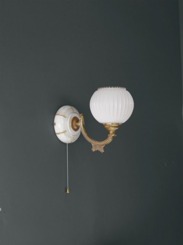 Golden brass wall sconce with white striped blown glass facing upward
