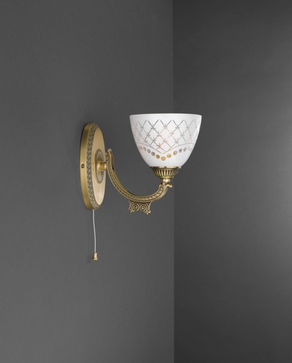 1 light brass wall sconce with white engraved glass facing upward