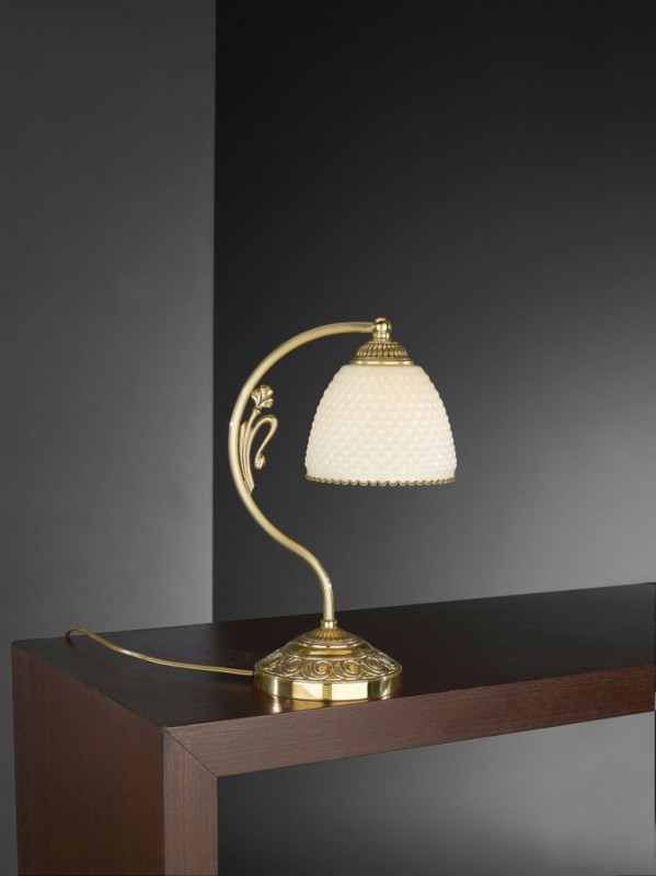 Golden brass bedside lamp with ivory glass