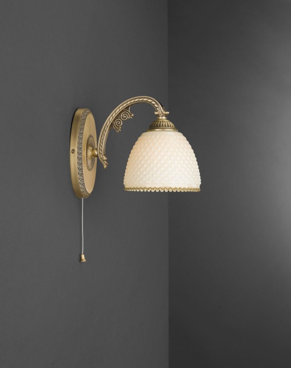 Brass wall sconce with ivory glass