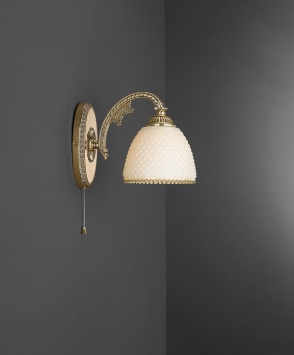Golden brass wall sconce with ivory glass