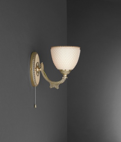Golden brass wall sconce with ivory glass facing upward