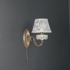 1 light brass and painted porcelain wall sconce with lamp shade. The lampshade fabric shown in the product photo is no longer available. The lampshades will be shipped with the new fabric as in the second photo.