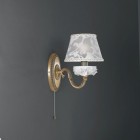 1 light brass and white porcelain wall sconce with lamp shade. The lampshade fabric shown in the product photo is no longer available. The lampshades will be shipped with the new fabric as in the second photo.