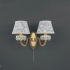 2 light golden brass and painted porcelain wall sconce with lamp shade. The lampshade fabric shown in the product photo is no longer available. The lampshades will be shipped with the new fabric as in the second photo.